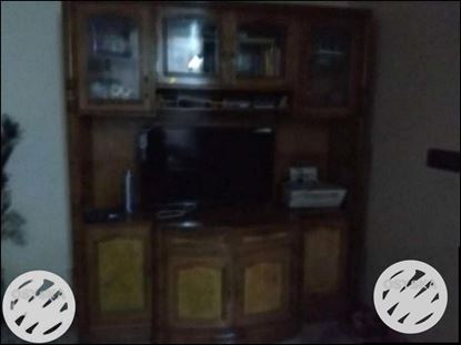 Brown Wooden TV Hutch With Flat Screen Television