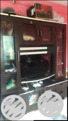 Black Flat Screen TV With Brown Wooden TV Hutch