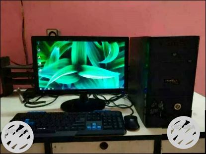 Black Computer Monitor, Keyboard, Mouse, And Tower